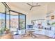 Modern home office with sleek desk, custom built-ins, and stunning views from expansive windows at 7701 N Silvercrest Way, Paradise Valley, AZ 85253