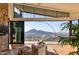 Stylish living room boasts stunning mountain views, a stone accent wall, and modern decor at 7701 N Silvercrest Way, Paradise Valley, AZ 85253