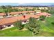 Aerial view of townhomes with red tile roofs nestled near a scenic golf course at 7755 E Laguna Azul Ave # 184, Mesa, AZ 85209