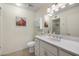 Bright bathroom with white cabinetry, a sink, and a well-lit mirror at 7755 E Laguna Azul Ave # 184, Mesa, AZ 85209