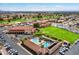 Overhead shot of the community pools, surrounded by lounge chairs, lush landscaping, and well-maintained lawns at 7755 E Laguna Azul Ave # 184, Mesa, AZ 85209