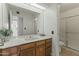 Bright bathroom featuring a large mirror, updated lighting and neutral shower at 839 S Westwood -- # 273, Mesa, AZ 85210