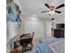 Comfortable bedroom featuring a ceiling fan, a desk and chair, plus plentiful closet space at 9809 W Pleasant Valley Rd, Sun City, AZ 85351