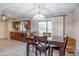 The dining room boasts wood floors and leads to the kitchen area through a sliding glass door at 9809 W Pleasant Valley Rd, Sun City, AZ 85351