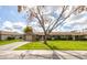 Attractive single-level home featuring a well-kept lawn and a long driveway leading to the garage at 9809 W Pleasant Valley Rd, Sun City, AZ 85351