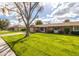 Charming single-story home featuring a well-manicured lawn and mature shade tree in a quiet neighborhood at 9809 W Pleasant Valley Rd, Sun City, AZ 85351