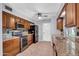 The kitchen features granite countertops, wooden cabinets, stainless steel appliances, and tiled backsplash at 9809 W Pleasant Valley Rd, Sun City, AZ 85351