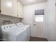 Clean laundry room with washer, dryer, and storage cabinets, offering functionality and convenience at 9809 W Pleasant Valley Rd, Sun City, AZ 85351