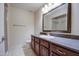 Well-appointed bathroom showcasing a vanity with dark wood cabinets and a glass-enclosed shower, enhancing comfort and style at 10115 E Mountain View Rd # 1005, Scottsdale, AZ 85258