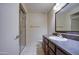 A well-lit bathroom with a glass-enclosed shower, and a classic vanity with dark wood cabinets at 10115 E Mountain View Rd # 1005, Scottsdale, AZ 85258