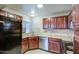 Traditional kitchen featuring granite countertops, tile backsplash, stainless steel appliances, and tiled floors at 10115 E Mountain View Rd # 1005, Scottsdale, AZ 85258