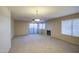 Open living room with sliding door to patio with fireplace and neutral carpet at 10115 E Mountain View Rd # 1005, Scottsdale, AZ 85258