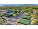 Overhead shot captures tennis courts, a clubhouse with pool, parking, and surrounding natural landscape at 10561 E Addy Way, Scottsdale, AZ 85262