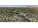 Expansive overhead view featuring a golf course, tennis courts, community pool, and homes at 10561 E Addy Way, Scottsdale, AZ 85262