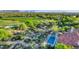 Overhead view showcasing a lush golf course nearby a home with a sparkling blue pool at 10561 E Addy Way, Scottsdale, AZ 85262