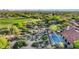 Aerial shot featuring a golf course near a property with pool and lush desert landscaping at 10561 E Addy Way, Scottsdale, AZ 85262