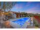 Beautiful backyard featuring a pool, covered patio, desert landscaping, and relaxing lounge area at 10561 E Addy Way, Scottsdale, AZ 85262