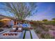 Inviting backyard with a pool, fire pit, and comfortable lounge seating at 10561 E Addy Way, Scottsdale, AZ 85262