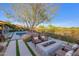Inviting backyard featuring pool, fire pit, lounge chairs and lush desert landscaping at 10561 E Addy Way, Scottsdale, AZ 85262