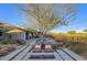 Elegant backyard with pool, fire pit, lounge chairs, and lush landscaping at 10561 E Addy Way, Scottsdale, AZ 85262
