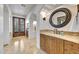 Bathroom with a marble topped vanity, decorative lighting, and tiled flooring at 10561 E Addy Way, Scottsdale, AZ 85262