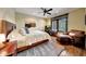 Comfortable bedroom featuring a large bed, wood floors, and a cozy leather chair at 10561 E Addy Way, Scottsdale, AZ 85262