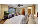 Bedroom with a large bed, wood floors, desk, and a cozy seating area at 10561 E Addy Way, Scottsdale, AZ 85262
