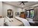 Comfortable bedroom featuring a ceiling fan, view to the outside, and a cozy sitting area at 10561 E Addy Way, Scottsdale, AZ 85262