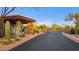 Entrance to luxury community with desert landscaping and an American flag at 10561 E Addy Way, Scottsdale, AZ 85262