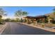 Elegant community entrance with stone pillars and desert landscaping at 10561 E Addy Way, Scottsdale, AZ 85262