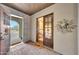 Inviting entryway with brick flooring, decorative door, and desert landscape view at 10561 E Addy Way, Scottsdale, AZ 85262