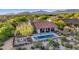 Expansive home with a red tile roof, pool, patio, and desert landscaping against a backdrop of mountains at 10561 E Addy Way, Scottsdale, AZ 85262