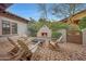 Cozy outdoor fireplace surrounded by rocking chairs in a charming backyard space at 10561 E Addy Way, Scottsdale, AZ 85262