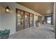 Covered outdoor patio features brick flooring, lighting, wood ceiling, and access through french doors to the interior at 10561 E Addy Way, Scottsdale, AZ 85262