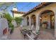 Charming outdoor patio with covered seating, stone pavers, and a lovely fireplace at 10561 E Addy Way, Scottsdale, AZ 85262