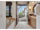 Inviting patio view with seating area, accessed through elegant wooden double doors at 10561 E Addy Way, Scottsdale, AZ 85262