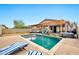 Lovely backyard with a pool, hot tub, lounge chairs, and covered patio at 10780 W Woodland Ave, Avondale, AZ 85323