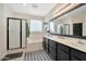 Bright bathroom featuring double sinks, soaking tub, and shower with black hardware at 10780 W Woodland Ave, Avondale, AZ 85323