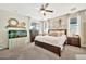 Serene bedroom featuring a ceiling fan, neutral color scheme, and an inviting atmosphere with ample natural light at 10780 W Woodland Ave, Avondale, AZ 85323