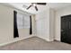Bedroom featuring carpet, a window with black curtains, and a closet with sliding doors at 10780 W Woodland Ave, Avondale, AZ 85323