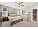 Inviting bedroom features a ceiling fan, neutral decor, and a spacious layout, creating a relaxing retreat at 10780 W Woodland Ave, Avondale, AZ 85323