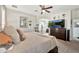 Relaxing bedroom with neutral tones, a ceiling fan, and ensuite bathroom access, creating a comfortable and private space at 10780 W Woodland Ave, Avondale, AZ 85323