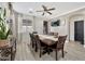 Spacious dining area featuring seating for eight, a modern ceiling fan, and a television mounted on the wall at 10780 W Woodland Ave, Avondale, AZ 85323