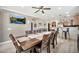 Open-concept dining area showcases a large table, seating for eight, and seamless flow into the kitchen space at 10780 W Woodland Ave, Avondale, AZ 85323