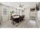 Bright dining room featuring a ceiling fan, large table with seating for eight, and sliding doors to the backyard at 10780 W Woodland Ave, Avondale, AZ 85323