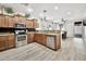 Modern kitchen with stainless steel appliances, granite counters, and wood flooring at 10780 W Woodland Ave, Avondale, AZ 85323