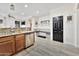 Modern kitchen boasts stainless steel appliances and granite countertops, flowing into cozy dining nook with built-in bench at 10780 W Woodland Ave, Avondale, AZ 85323