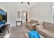 Another view of the bright living room showcasing the stylish archway and decor at 10780 W Woodland Ave, Avondale, AZ 85323