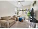 Cozy living room with plush seating, arched windows, and bright natural light at 10780 W Woodland Ave, Avondale, AZ 85323