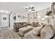 Spacious living room with two sofas, decorative wall art, curtains, and wood floors at 10780 W Woodland Ave, Avondale, AZ 85323